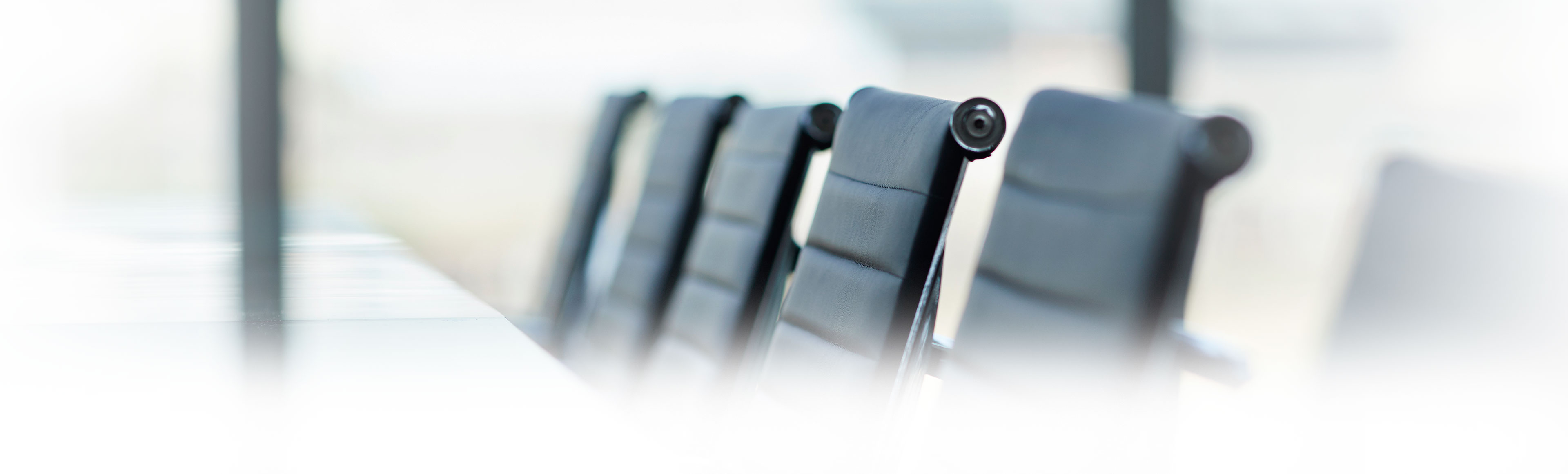 Row of black office chairs in meeting room