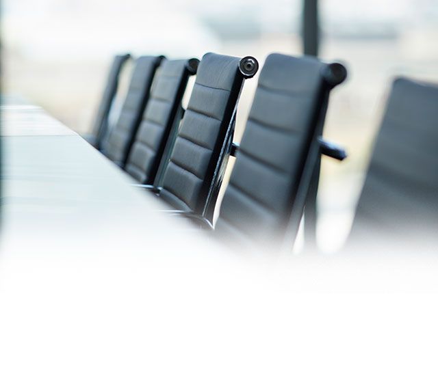 Row of black office chairs in meeting room