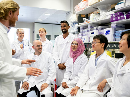 Smiling colleagues in lab coats