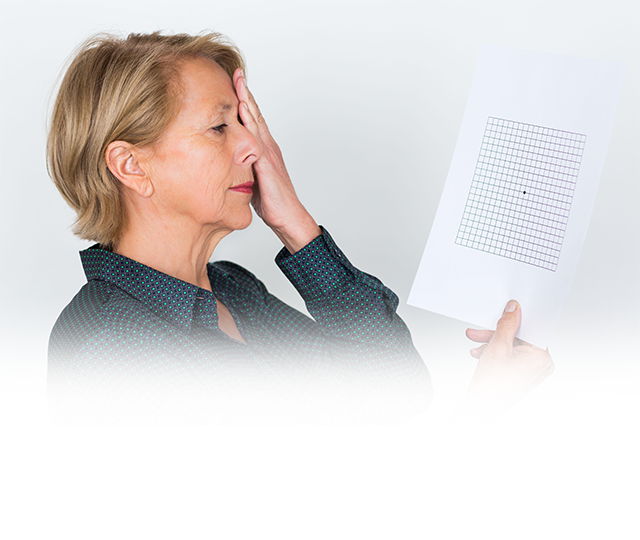 Senior woman covering one eye while taking an eye exam