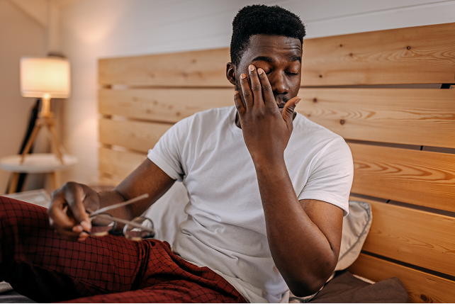 Man rubs his dry eyes